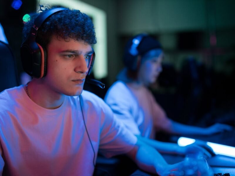 Man with Curly Hair Wearing Black Headset